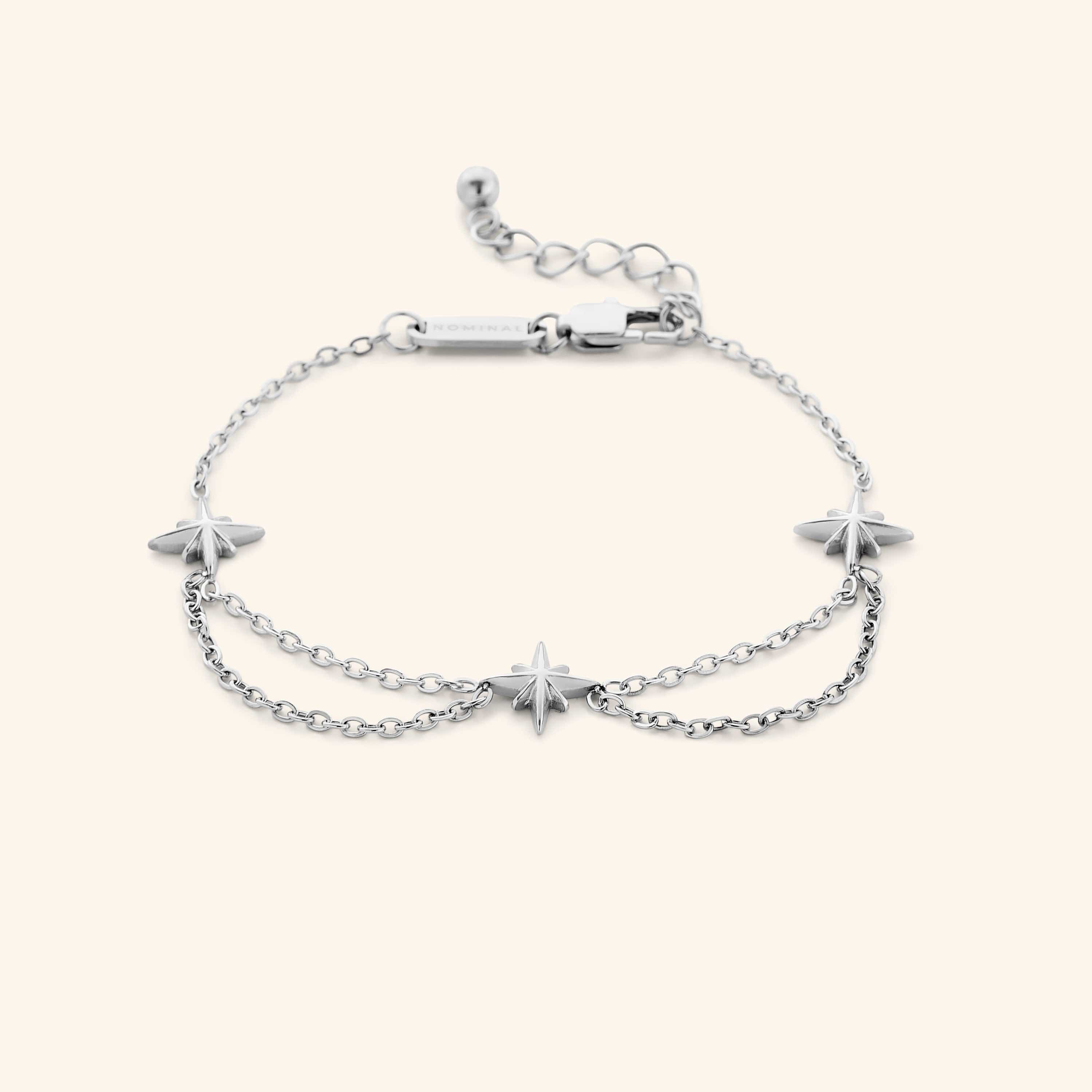 A silver bracelet that features north stars all along the chain, drooping chains connecting each one design.