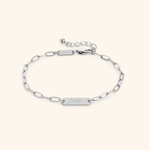 Silver Sakinah Serenity link bracelet showing the Arabic engraving on center tag, photographed against a light background.