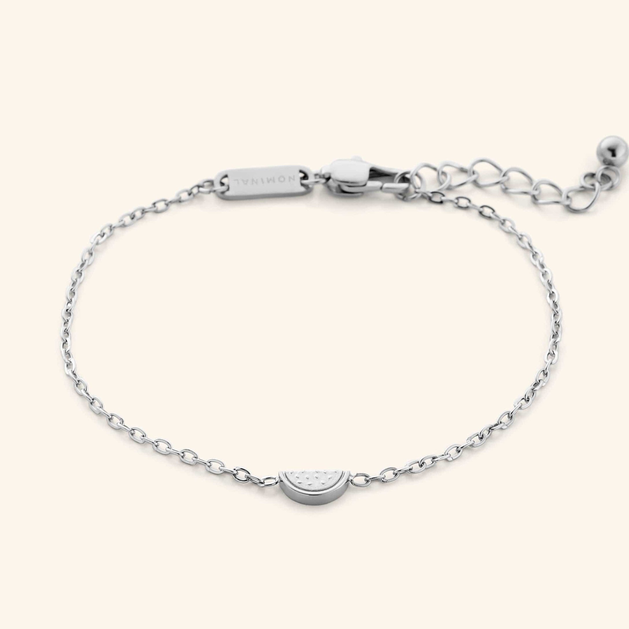 The Watermelon Bracelet in a polished silver finish. The bracelet showcases a delicate cable chain with a small, semi-circular pendant resembling a watermelon slice.