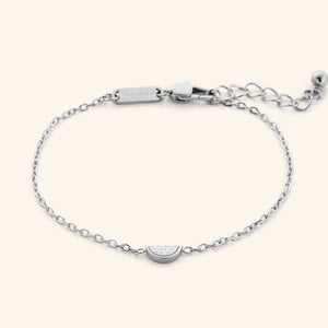 The Watermelon Bracelet in a polished silver finish. The bracelet showcases a delicate cable chain with a small, semi-circular pendant resembling a watermelon slice.