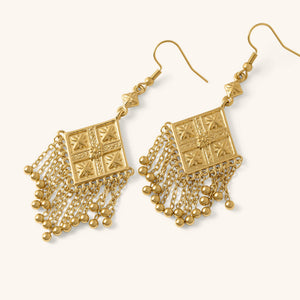 Gold Dancing Kite Earrings featuring square engraved motifs with dangling chains, shown against a neutral background.