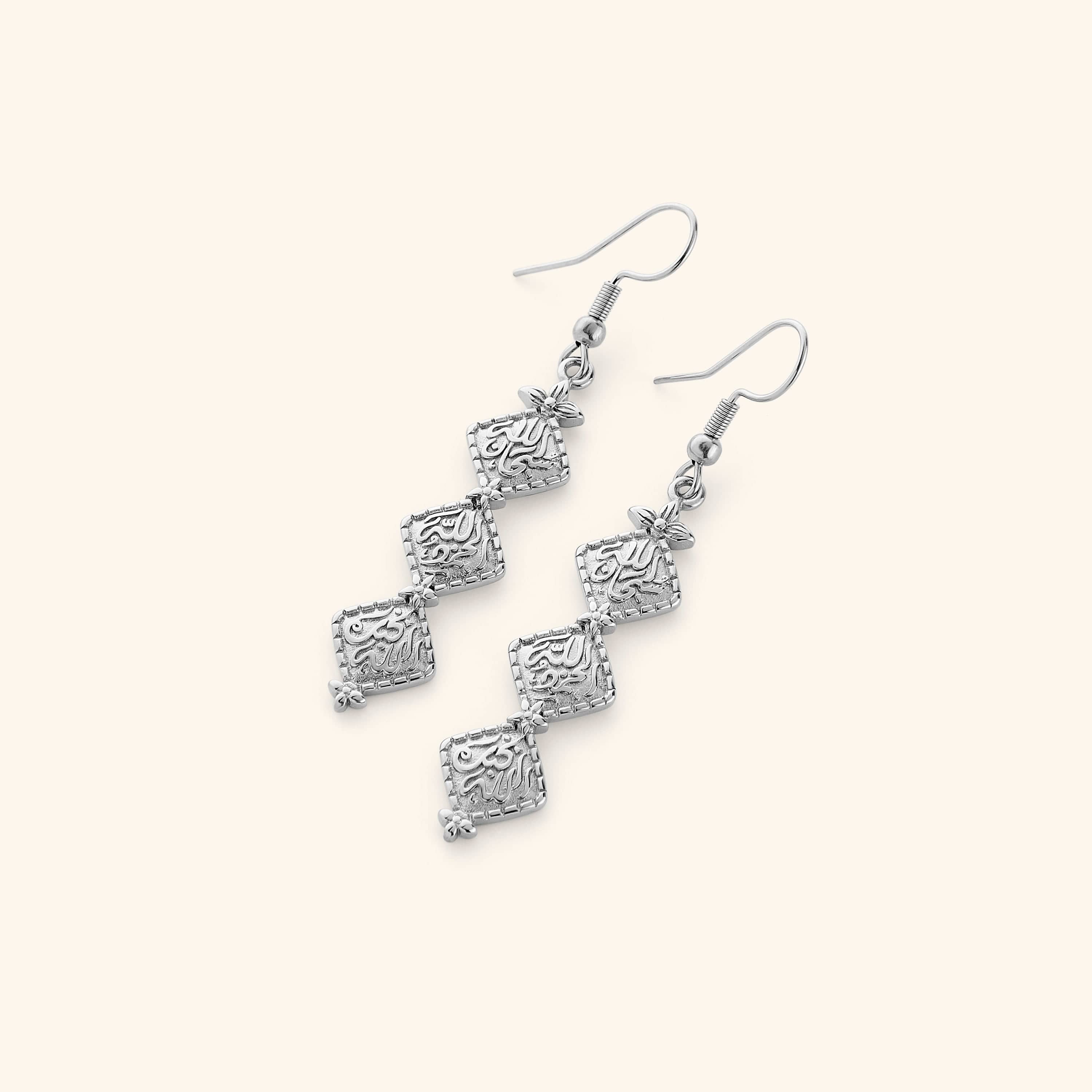 A pair of Silver earrings with vintage tradition of hammered gold while embossing thikr (the remembrance of Allah) on each diamond-shaped plate design.