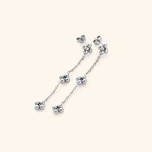 Close-up of the Dangling Henna Earrings in silver with bead clusters linked by a delicate chain.