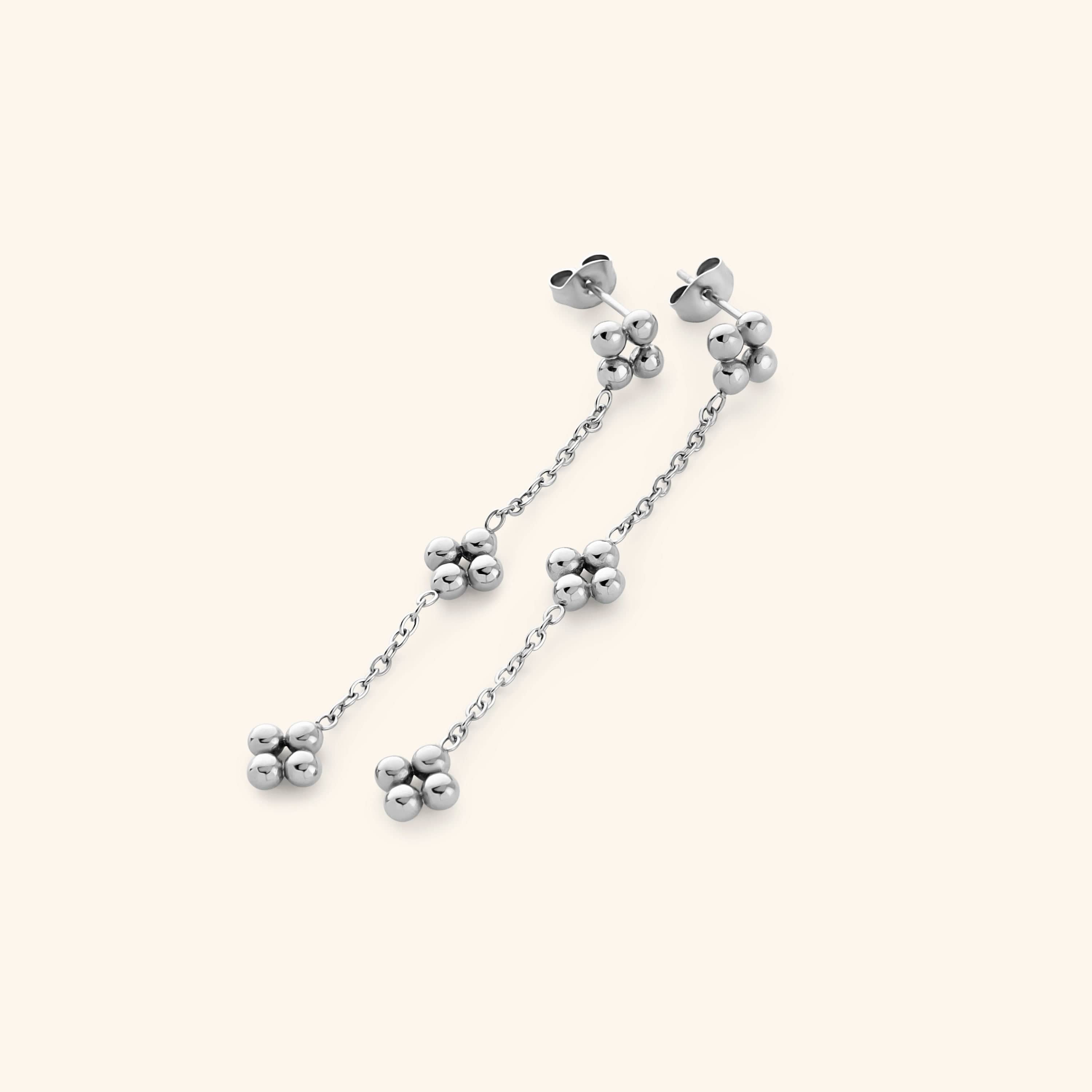 Close-up of the Dangling Henna Earrings in silver with bead clusters linked by a delicate chain.