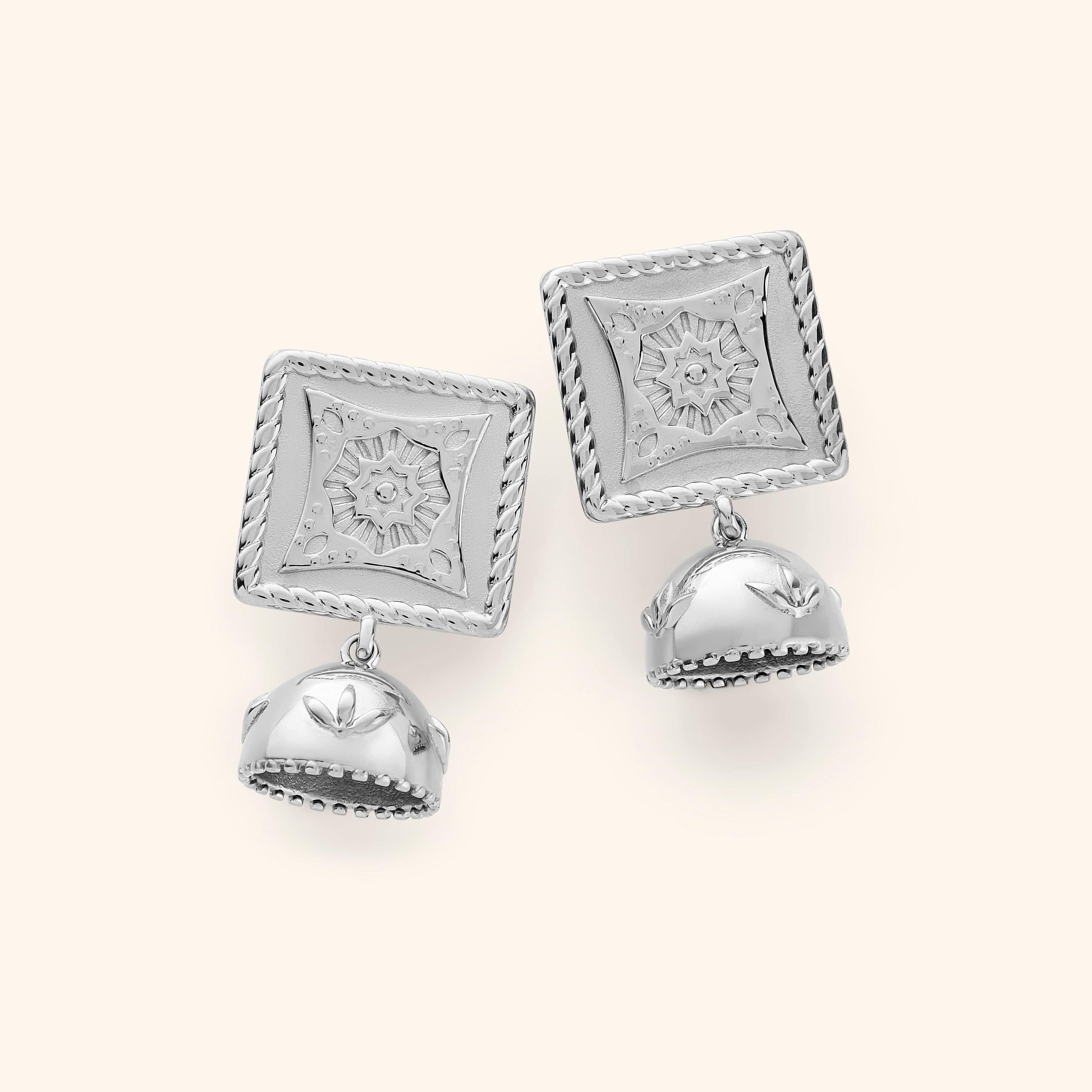 Pair of silver Square Jhumka Earrings featuring engraved square tops with floral star patterns and dangling dome-shaped jhumkas with leaf motifs, displayed on a neutral background.