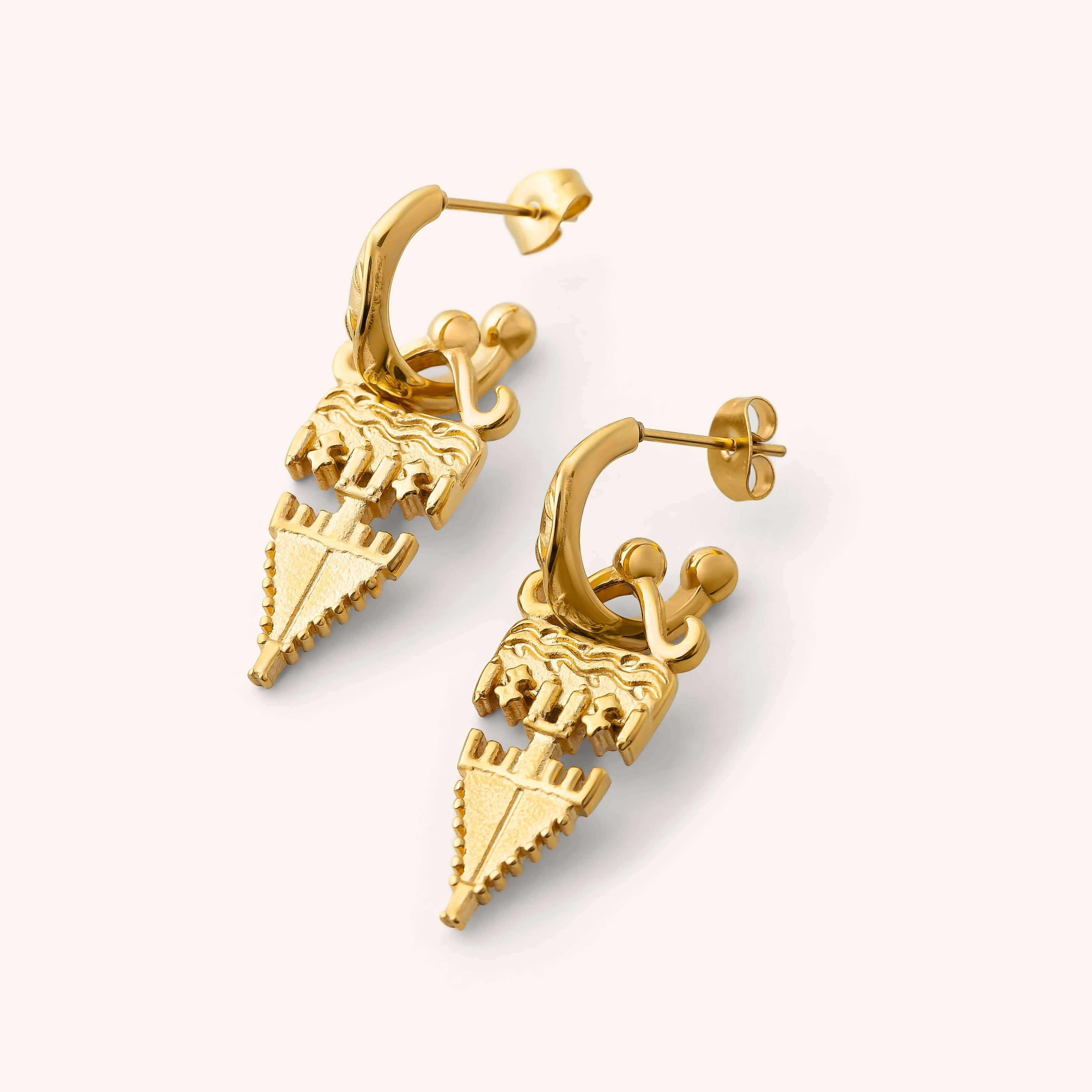 Gold Tatreez Earrings featuring textured geometric drops hanging from engraved hoop studs, shown against a neutral background.
