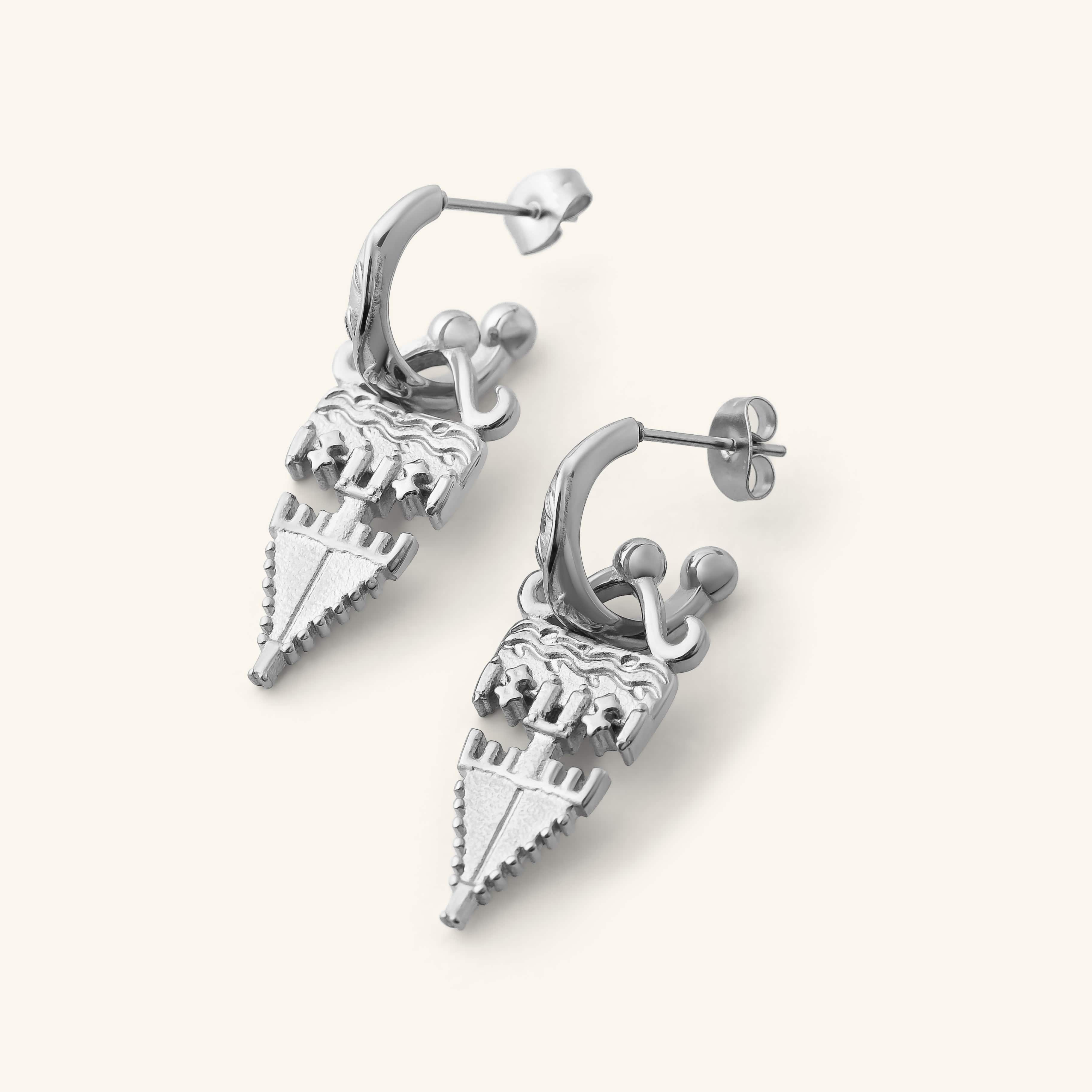 Silver Tatreez Earrings featuring textured geometric drops hanging from engraved hoop studs, shown against a neutral background.