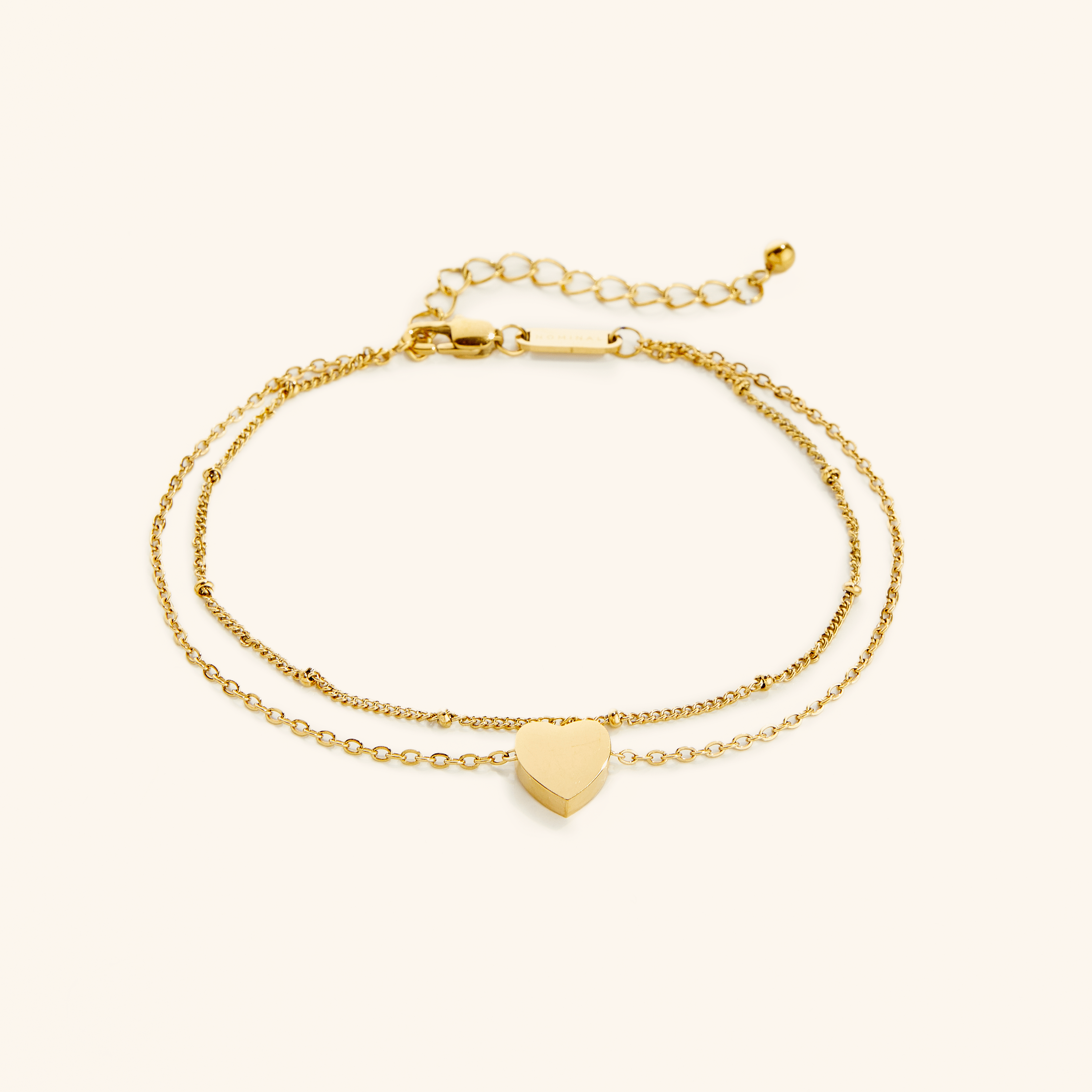 Flat lay of the 18k gold plated Dotted & Heart Stacker Anklet