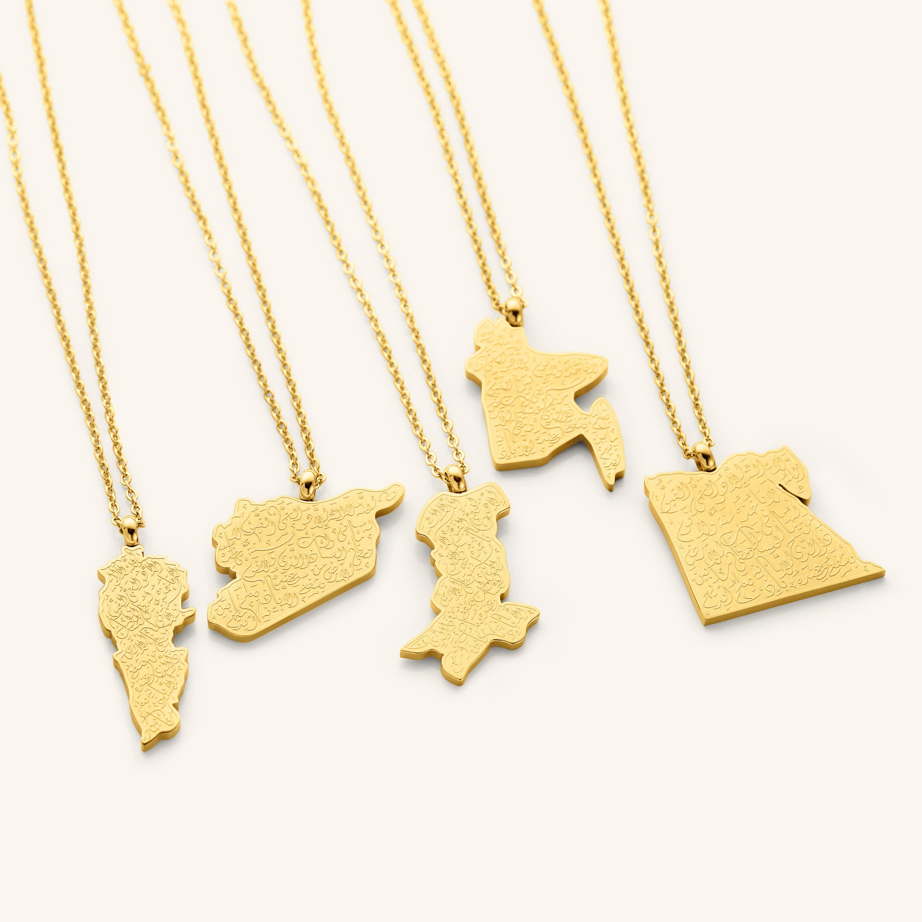 A close-up shot of the pendant, showcasing the detailed Arabic engraving of Ayatul Kursi on the gold-plated country-shaped pendants.