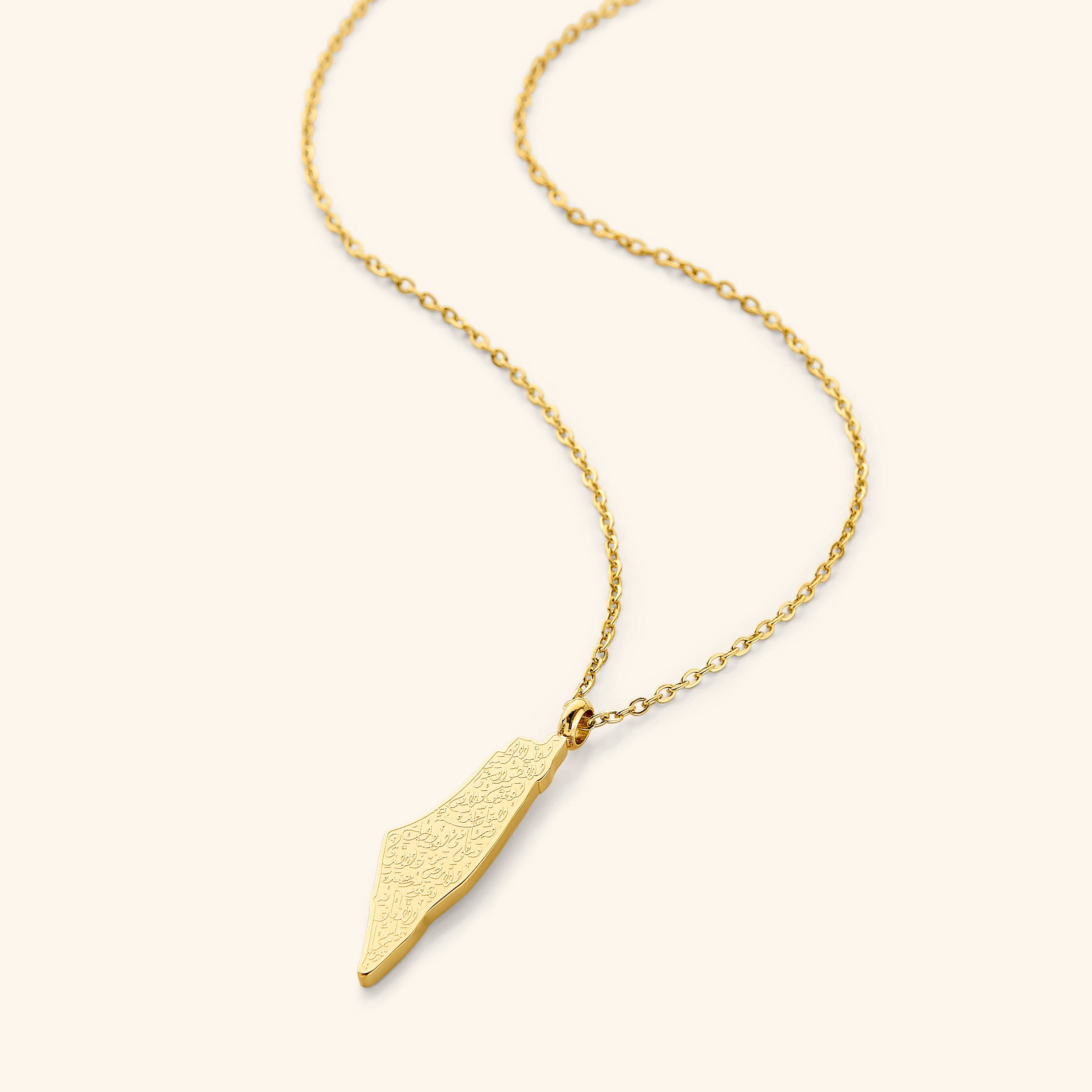 A gold-plated necklace featuring a pendant shaped like a country map, engraved with Arabic calligraphy of Ayatul Kursi, displayed on a white background.