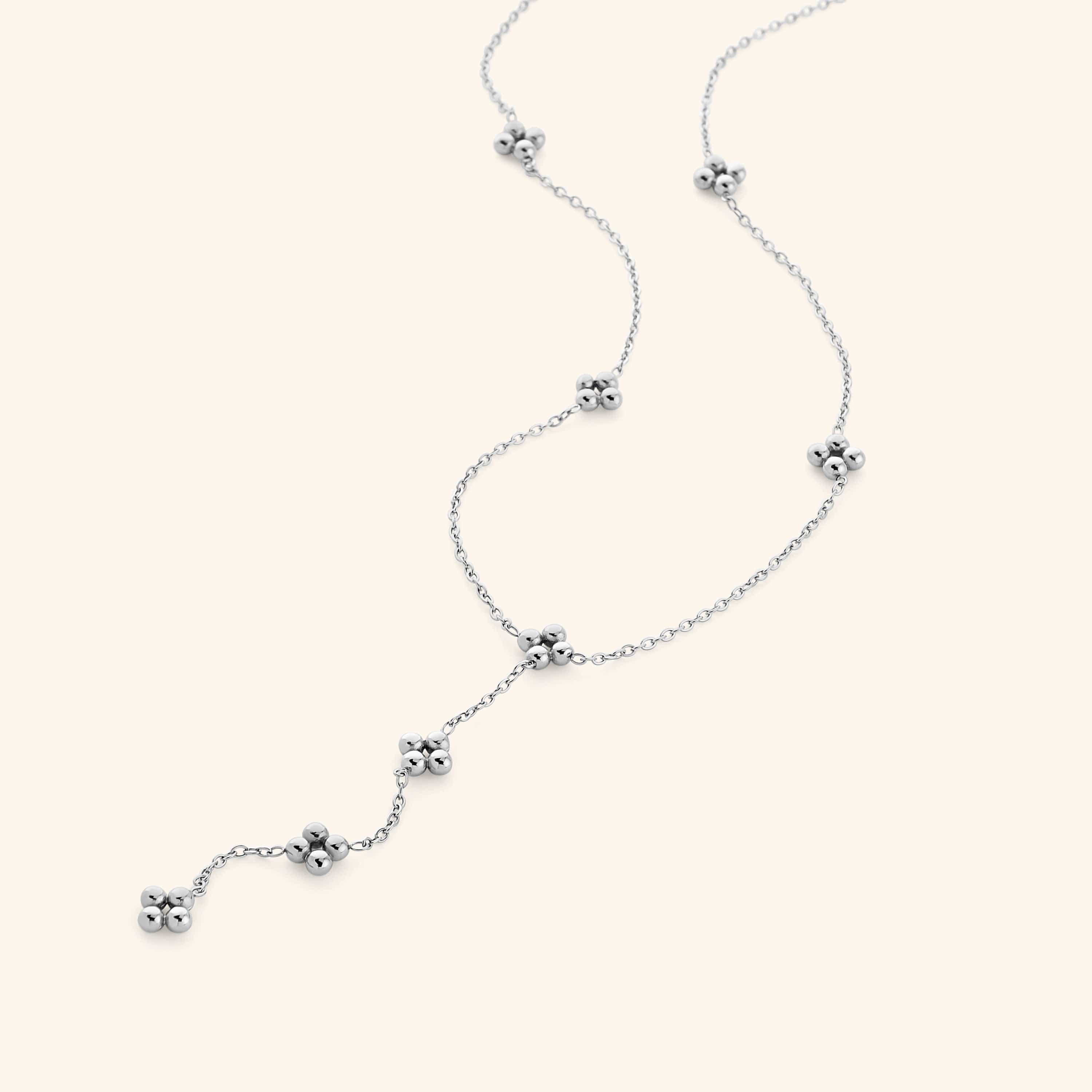 Close-up of the Henna Lariat Necklace in silver, featuring delicate chain links with small clustered bead accents and a drop lariat design.