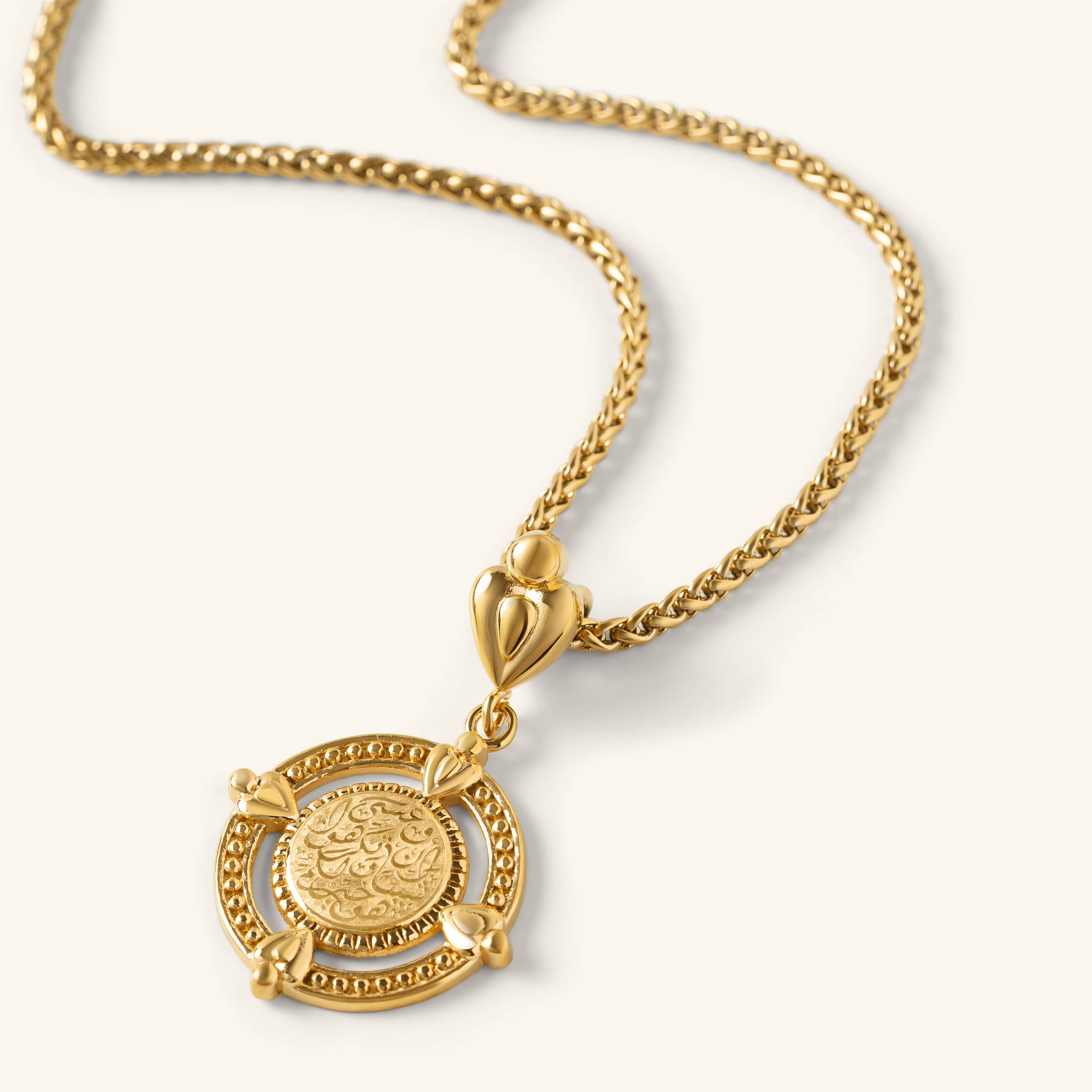 “Perhaps you dislike what's good for you” Coin Necklace in gold with engraved Arabic calligraphy and a decorative round frame.