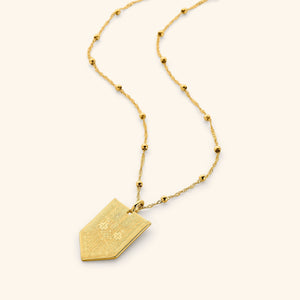 Necklace with 18K gold plated pointed tag pendant with design inspired by Tatreez on a dotted 18K Gold plated chain.