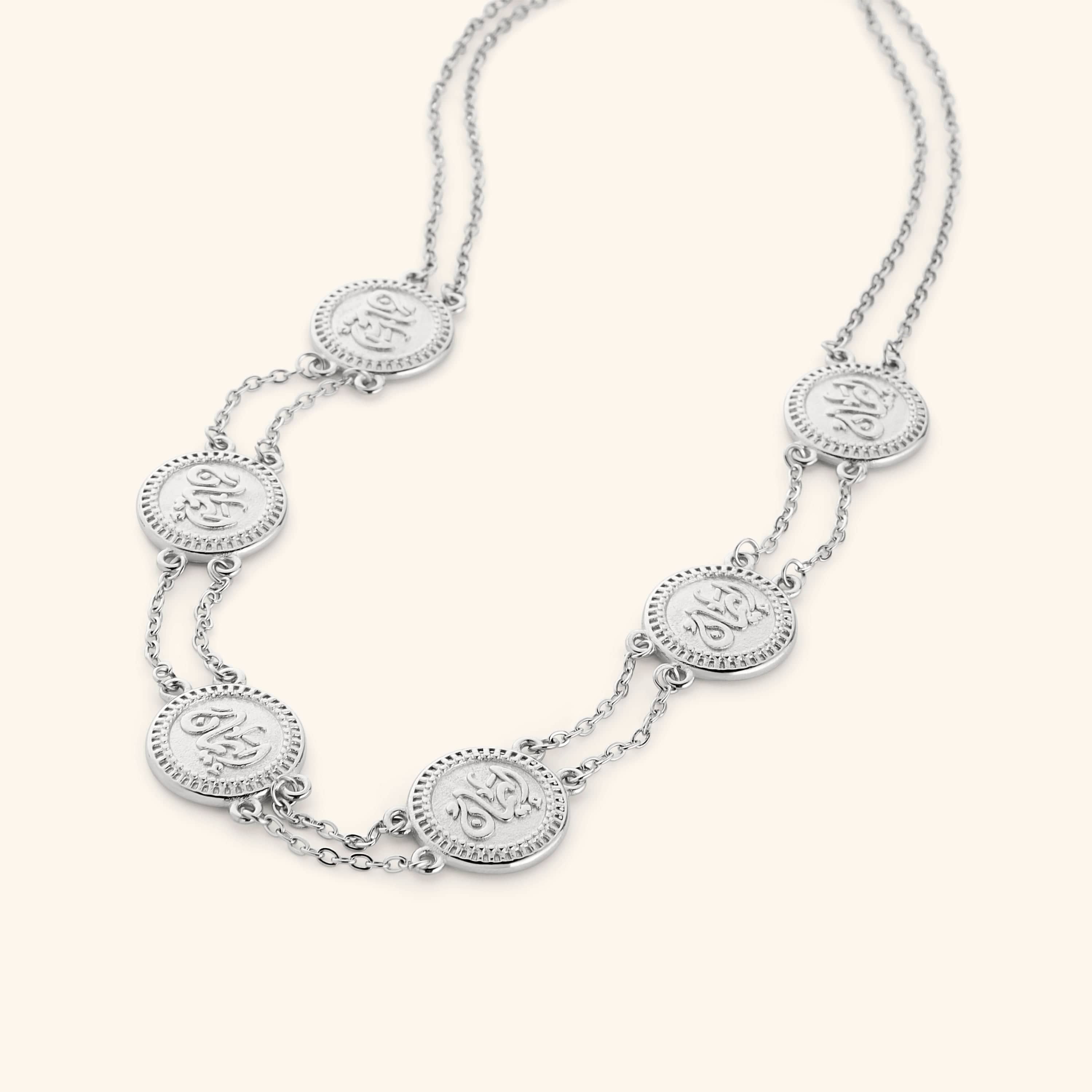 Silver layered necklace strung with coins stamped with إيمان (faith) in Arabic.