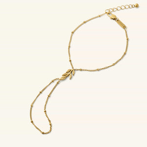 Palestinian Olive Branch Hand Chain in gold featuring a delicate chain and olive branch charm.