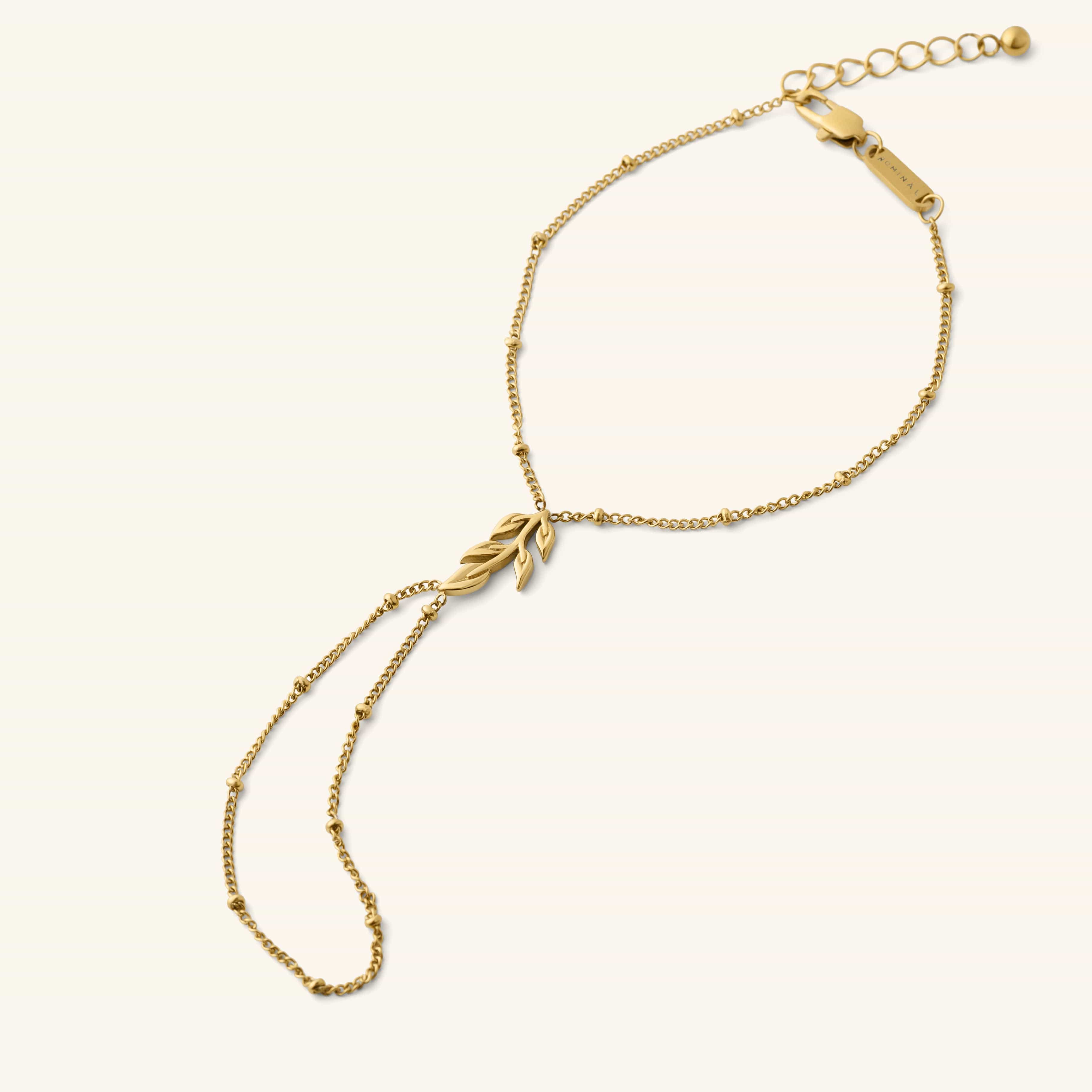 Palestinian Olive Branch Hand Chain in gold featuring a delicate chain and olive branch charm.