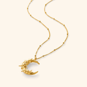 18K gold plated necklace. The pendant has poppy flower brought to the hopeful crescent on a thin dotted 18K gold plated chain.