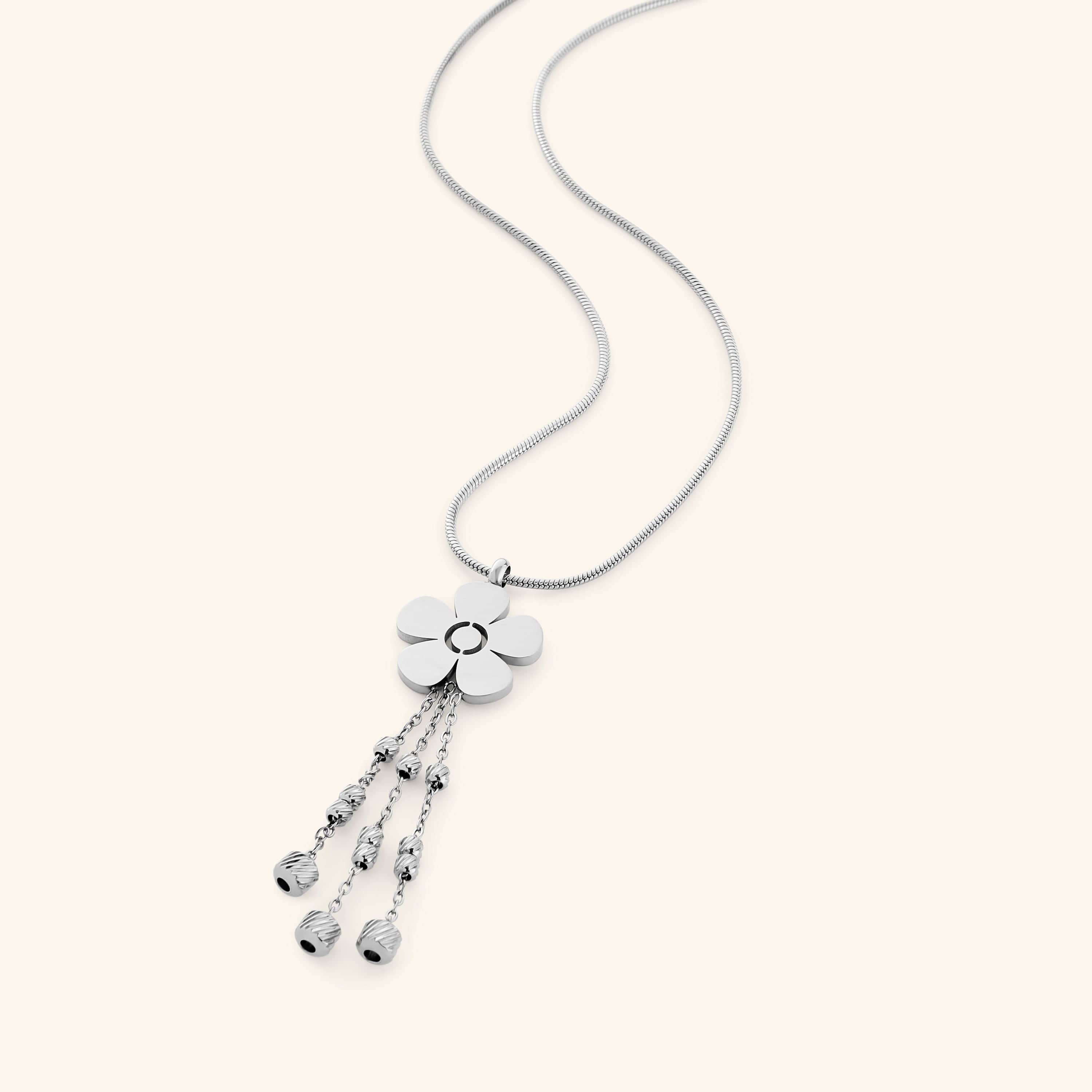Close-up of the silver Raining Flower Necklace worn on the neck, styled with matching earrings, showing the flower pendant with bead-detailed chains.