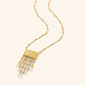 18K gold plated necklace featuring  a rectangular plate that is engraved with the patterns of the Palestinian keffiyeh, and then trailed with chains that are finished with pearl orbs. The necklace is finished with pearl orbs along the chain.