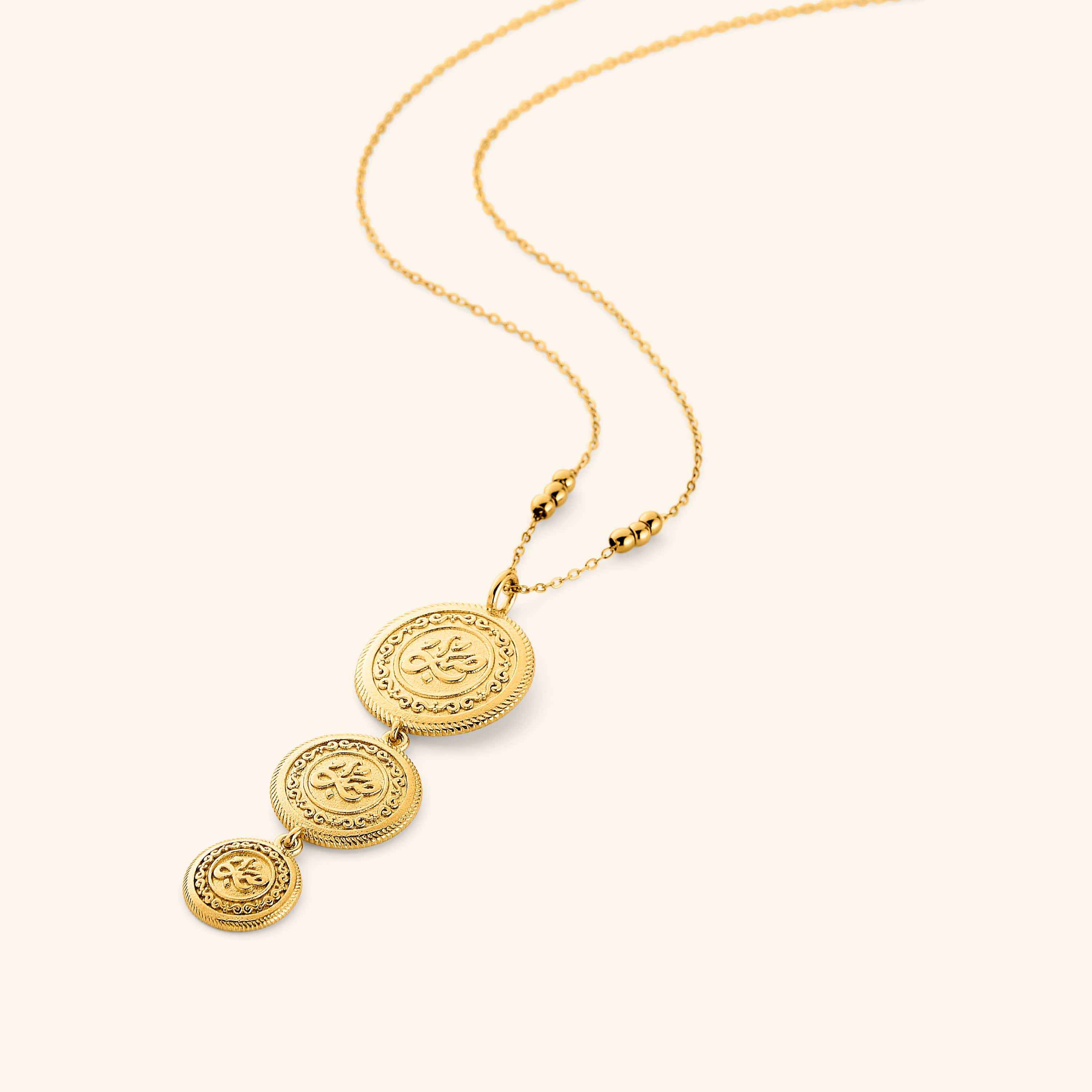 18k gold plated necklace that features three coins stacked and stamped with صبر (patience), hanging from a beaded chain, the coins are kept graduated in size, on a thin chain.
