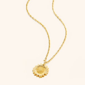 An 18k gold plated necklace that features a sunflower shaped pendant.