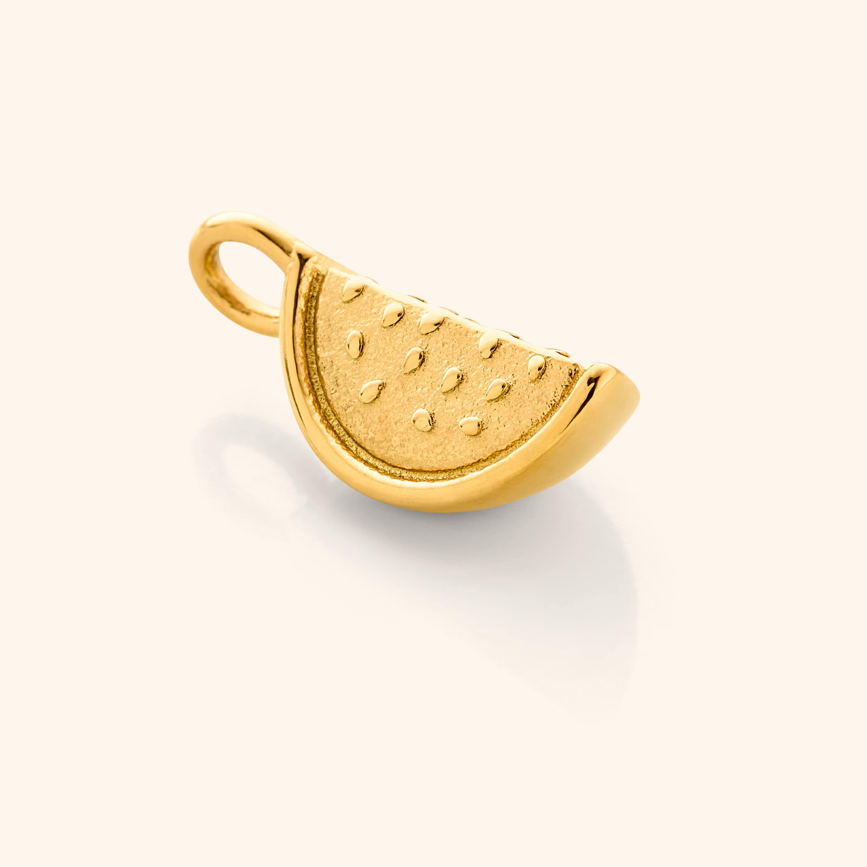 Close up of the gold Watermelon Earring Hoop Charm against a white background.