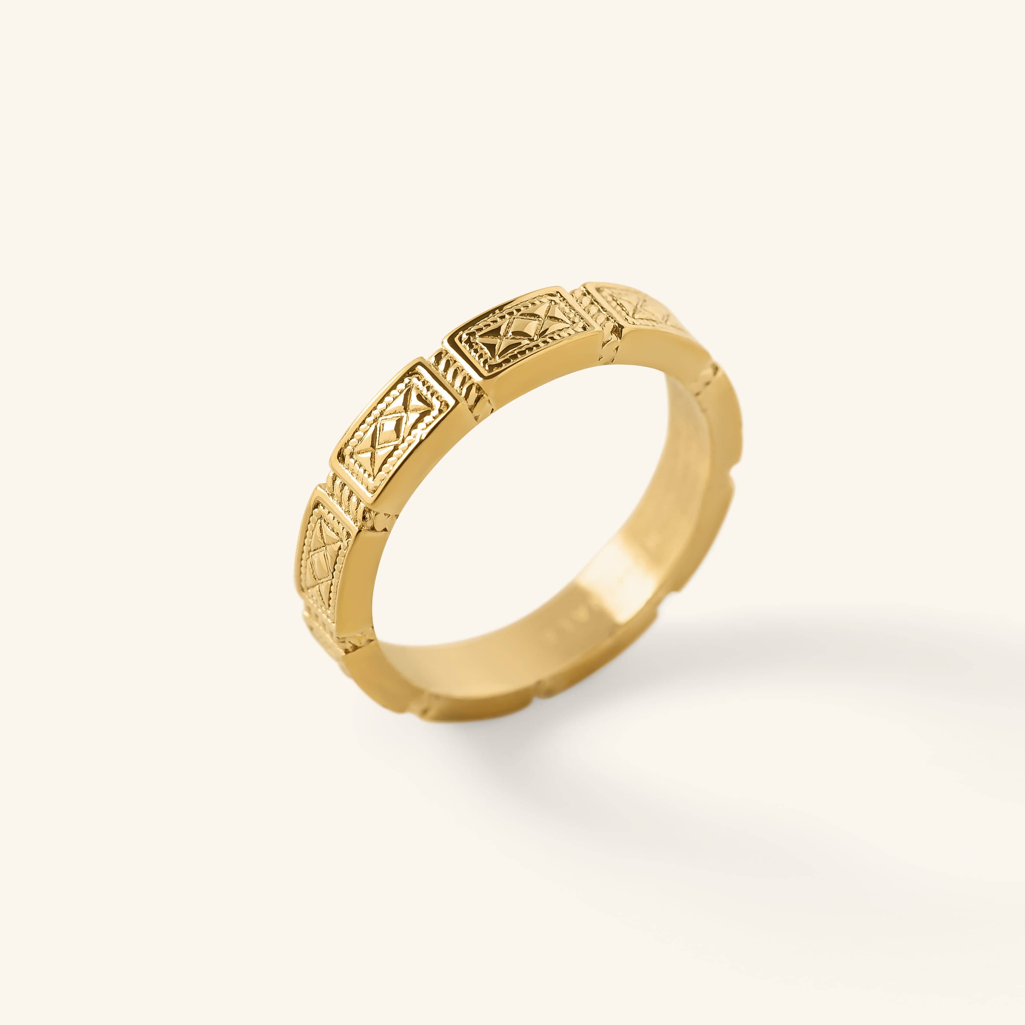 Gold Damascus Tile Ring with repeating engraved tile-style patterns shown against a neutral background.