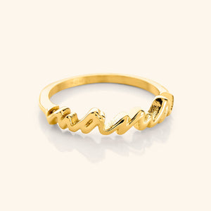 A close-up of the English Mama Ring in 18K gold plating. The ring features the word "Mama" in cursive script.
