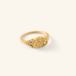Gold Homeland Ring with an oval face engraved in Arabic calligraphy and a decorative band, shown against a neutral background.