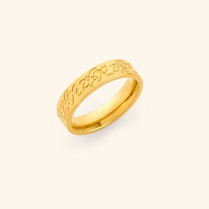 Gold Hurriya Freedom ring with intricate arabic calligraphy on a light background