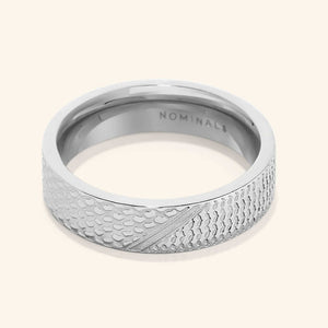 A close-up of the Keffiyeh Ring in silver, featuring intricate engravings inspired by the traditional Palestinian keffiyeh pattern, including fishnet designs, bold lines, and olive leaves.