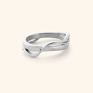 A silver ring where two bands intertwine to form the Arabic word for love, حب. 