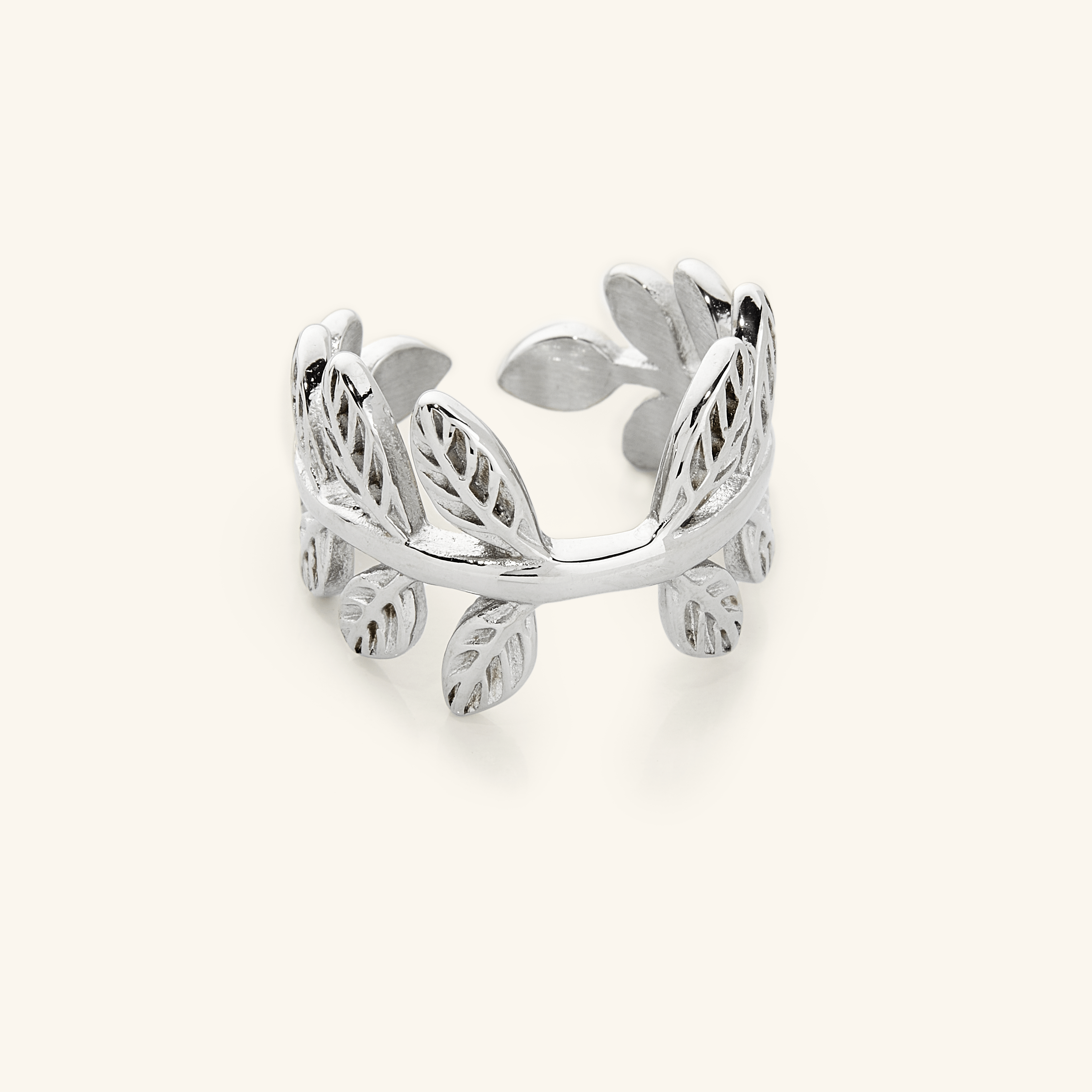 Close-up of a silver Olive Branch Ring with open wrap design, showcasing leaf engravings around the band.