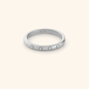 Silver ring featuring carved watermelon seeds along a clean band.