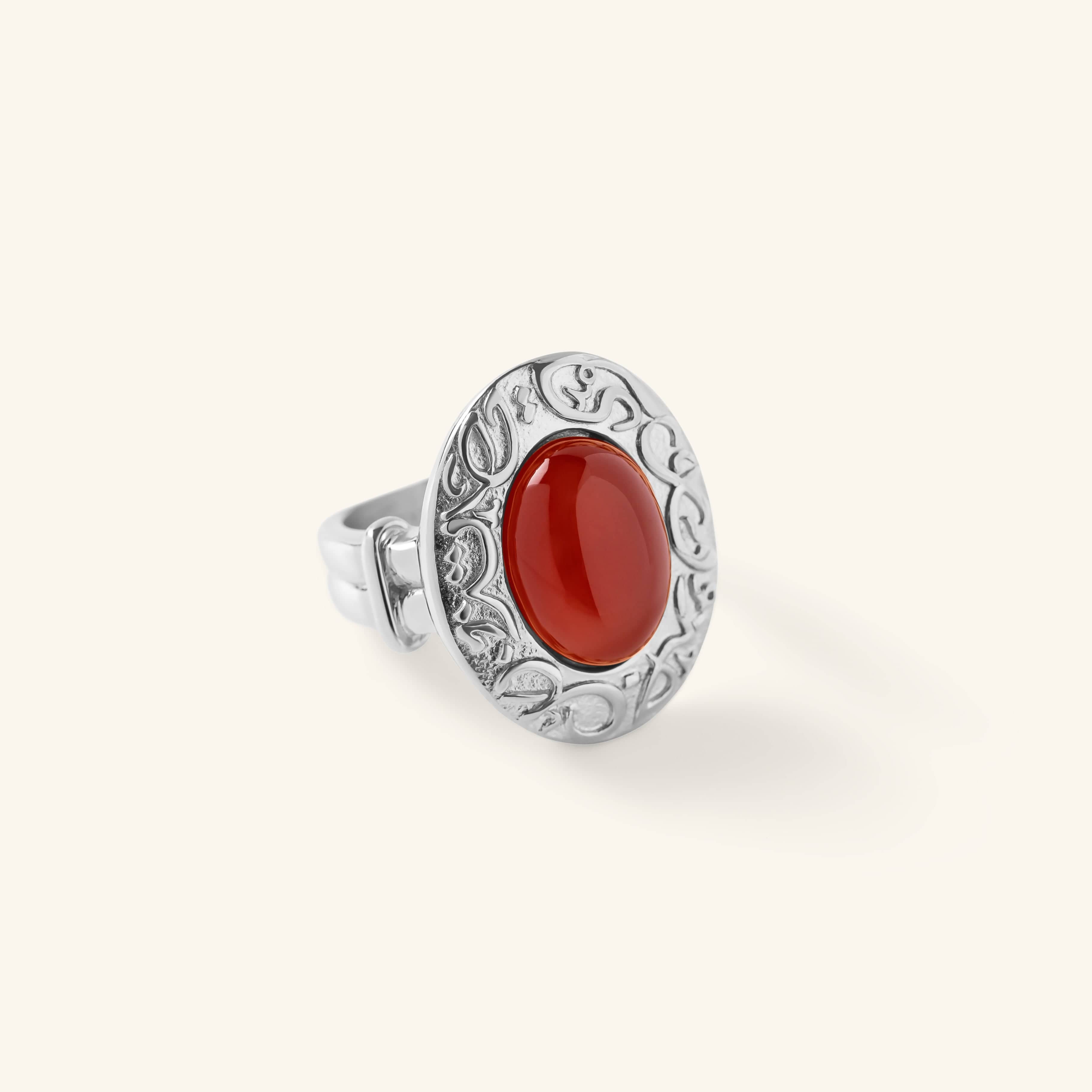 Close-up of the Roots Don’t Fade Stone Ring in silver, featuring an oval red stone set inside an engraved bezel with Arabic calligraphy.