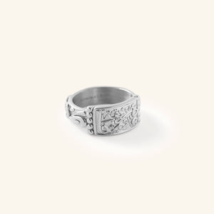 Silver “Our Roots Run Deep” Ring featuring raised Arabic calligraphy and textured detailing across a wide band, shown against a neutral background.