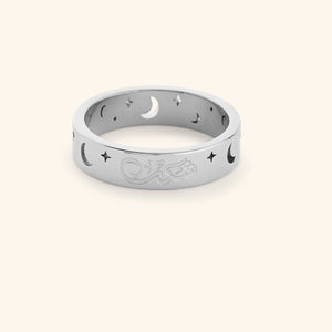 Silver ring with cutout star and moon design and an engraving that reads "Shukr", shot on a white background