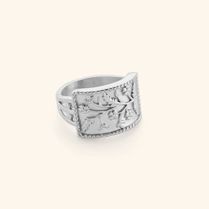 Silver Garden Ring with a curved rectangular face engraved with delicate floral vines and beaded edges.