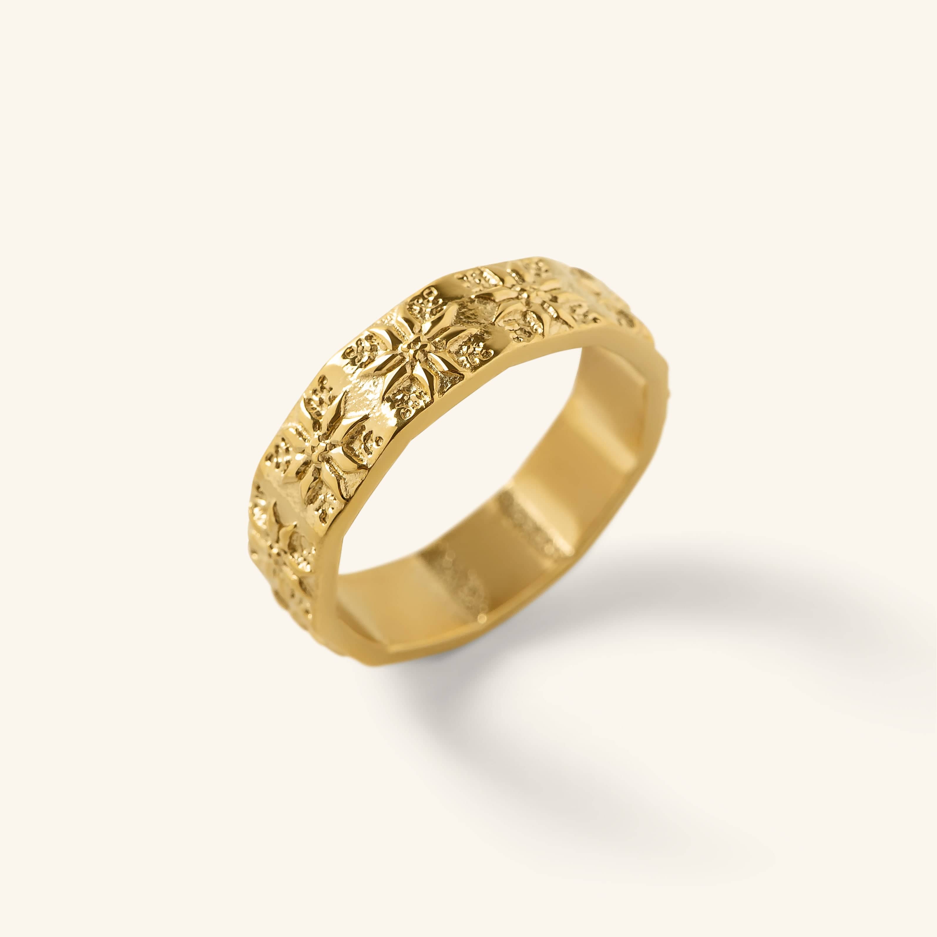 Gold Tatreez Ring with raised tatreez-inspired detailing shown against a neutral background.