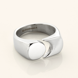 Silver Phases Ring shown close-up on a neutral background, featuring a thick band with a circular disc opposite a crescent cut-out design.