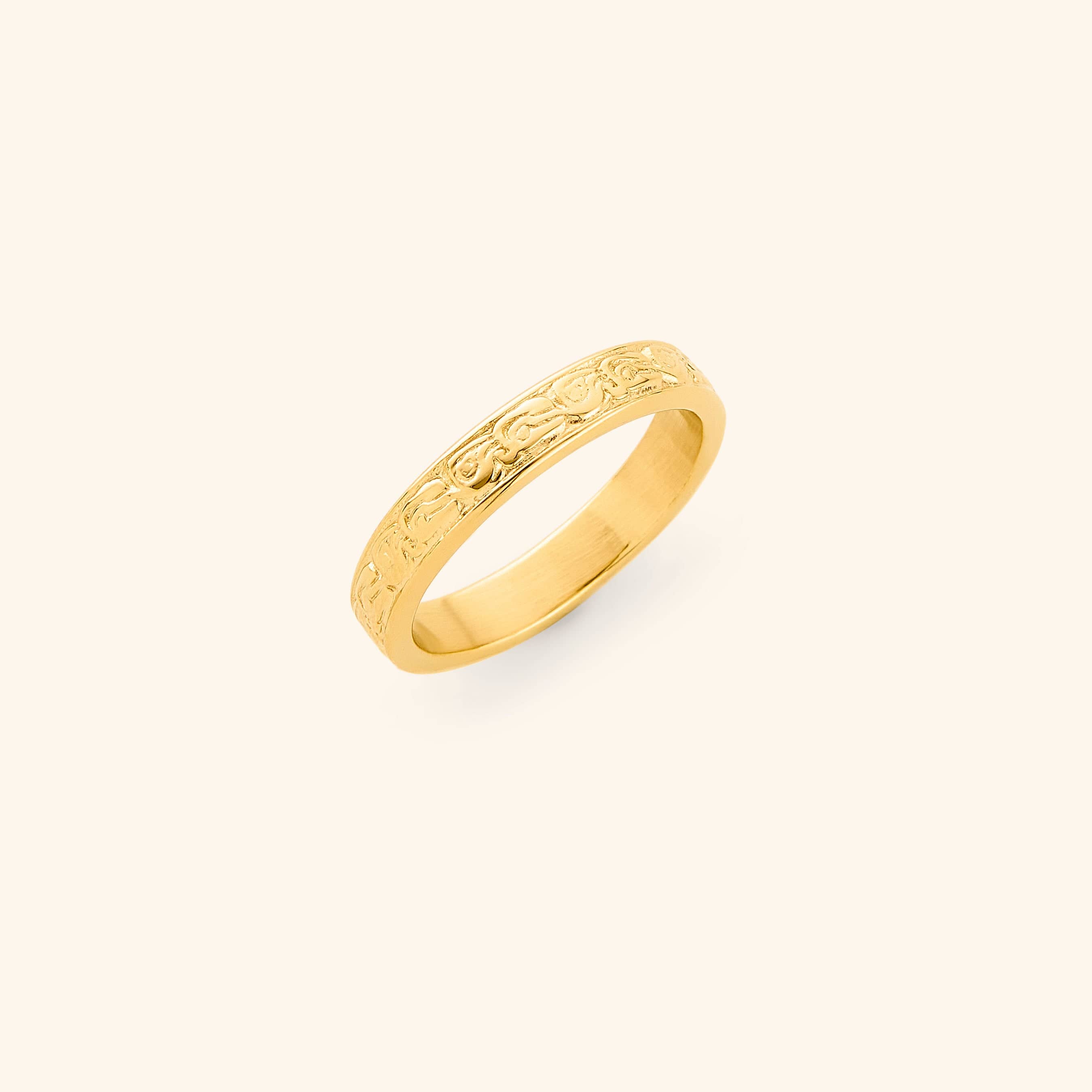 Gold vintage heritage ring with intricate design on a light background