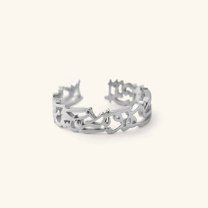 Silver “What Makes You Different Makes You Beautiful” Calligraphy Ring shown in a close-up shot, showing the open band and Arabic calligraphy.